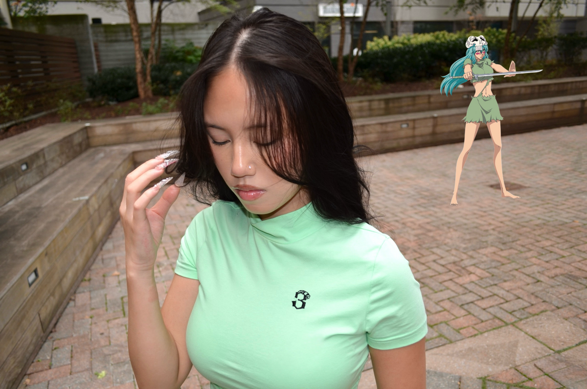 Model wearing Nel set back view, mint mock-neck shirt and mini skirt, Espada collection