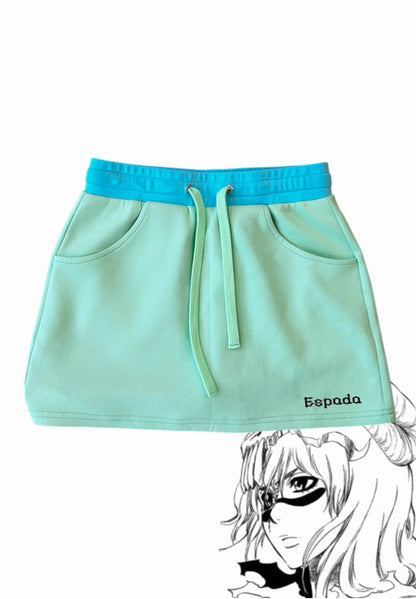 Nel mini skirt flat lay front, mint with contrast blue waistband, Espada hem embroidery